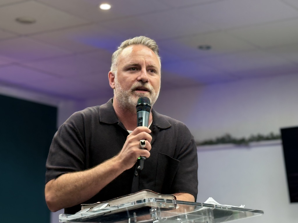 Mark Stevens speaking into a microphone at a lectern